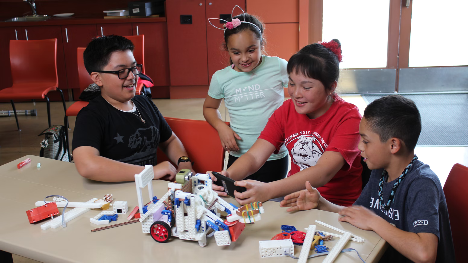 Group of kids building a robot