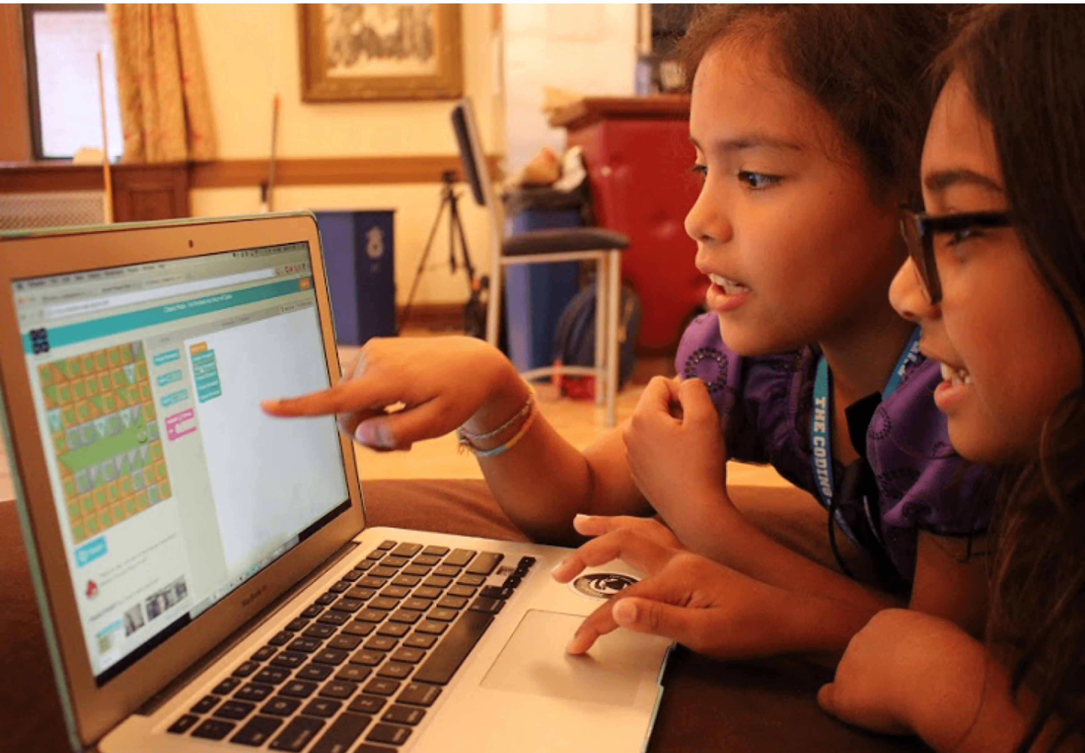 Two students coding on a computer