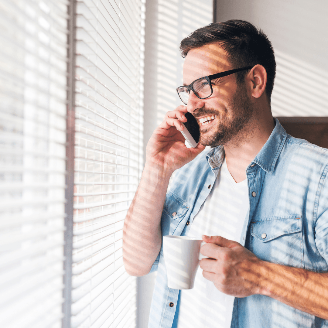 Man on phone at window