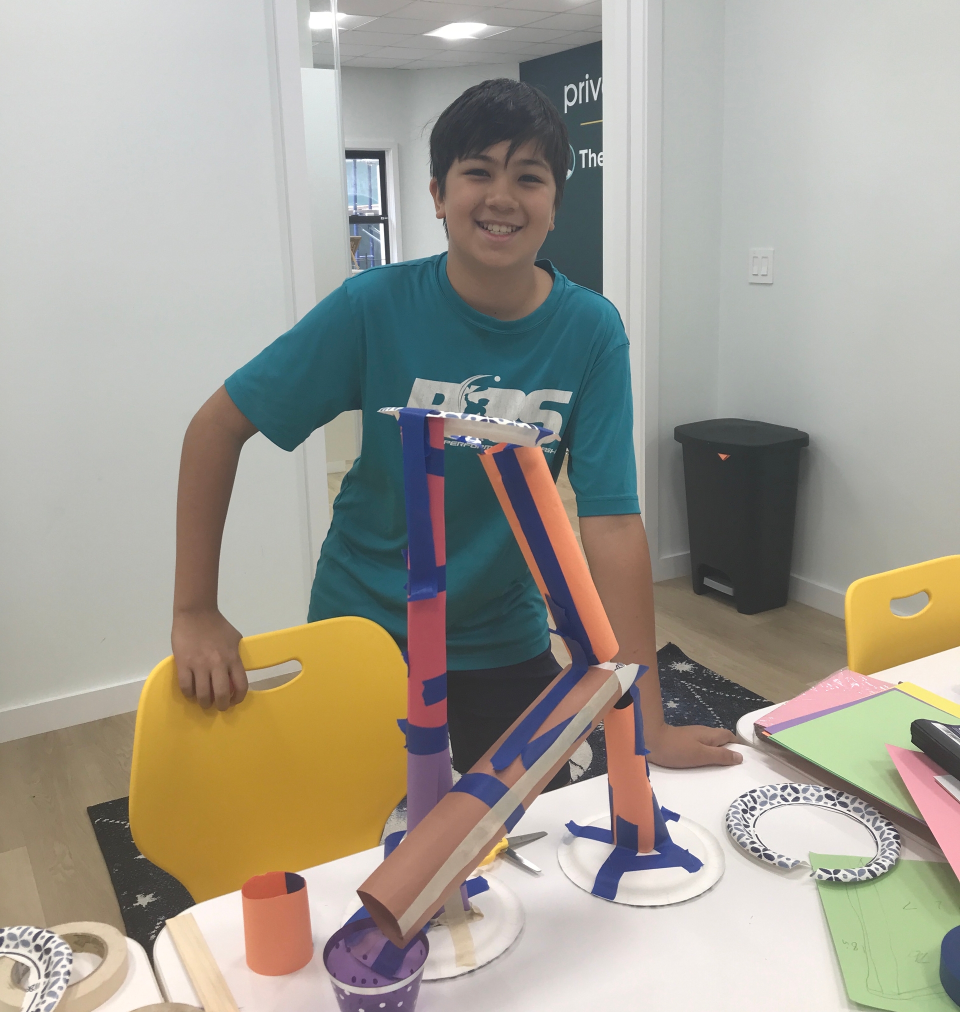 Teenage boy with cardboard roller coaster