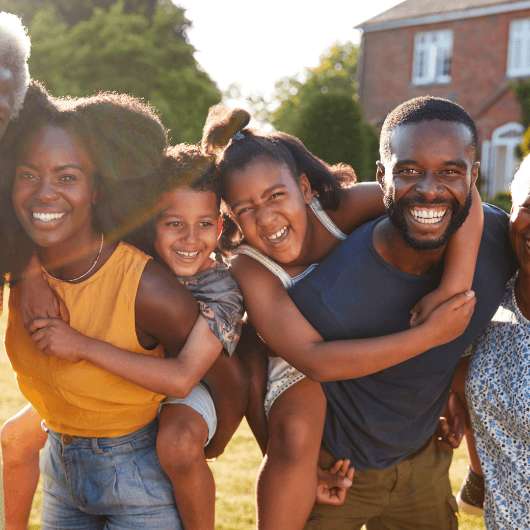 Black family smiling outside