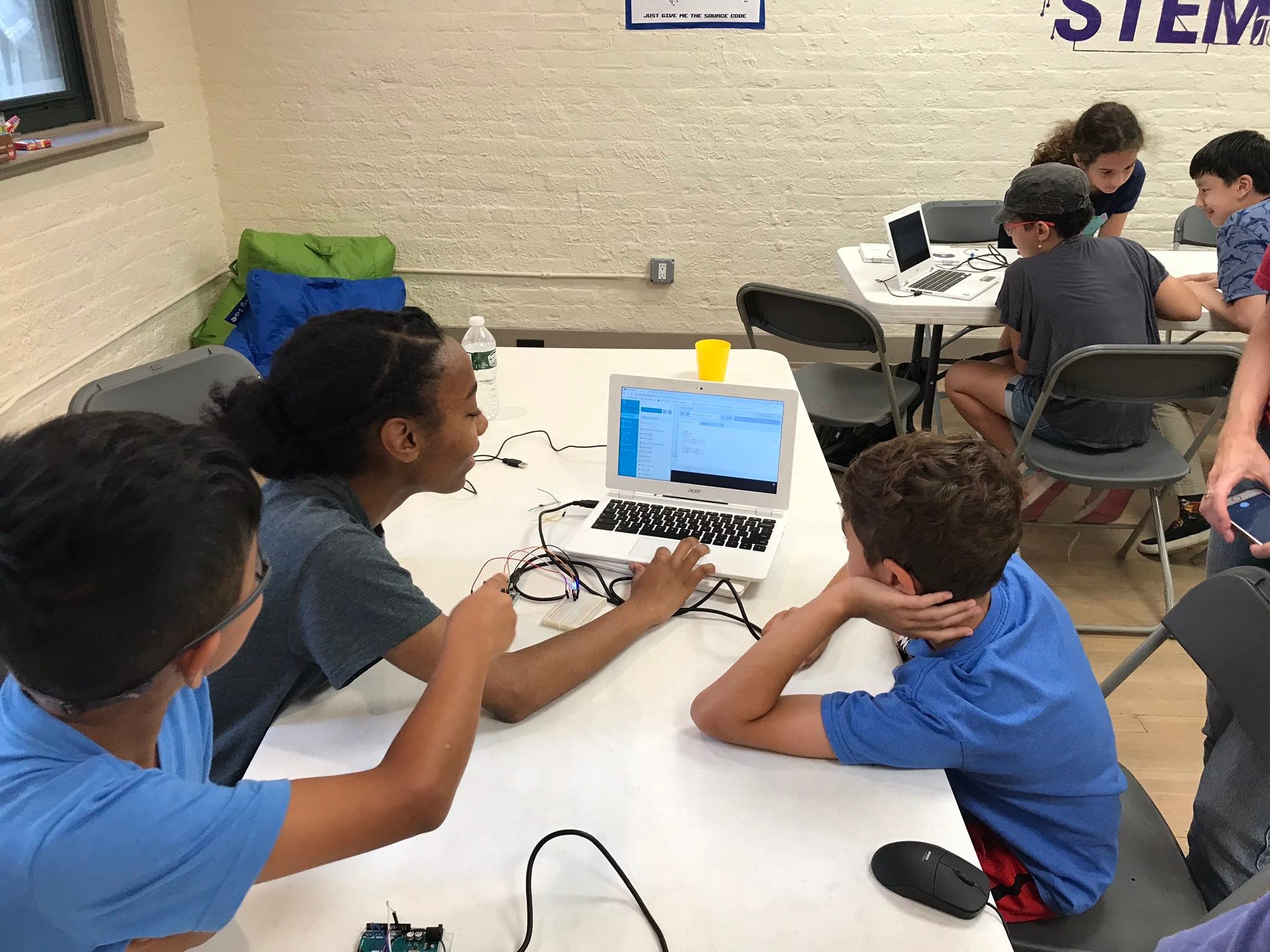 Kids working on on a computer in a group